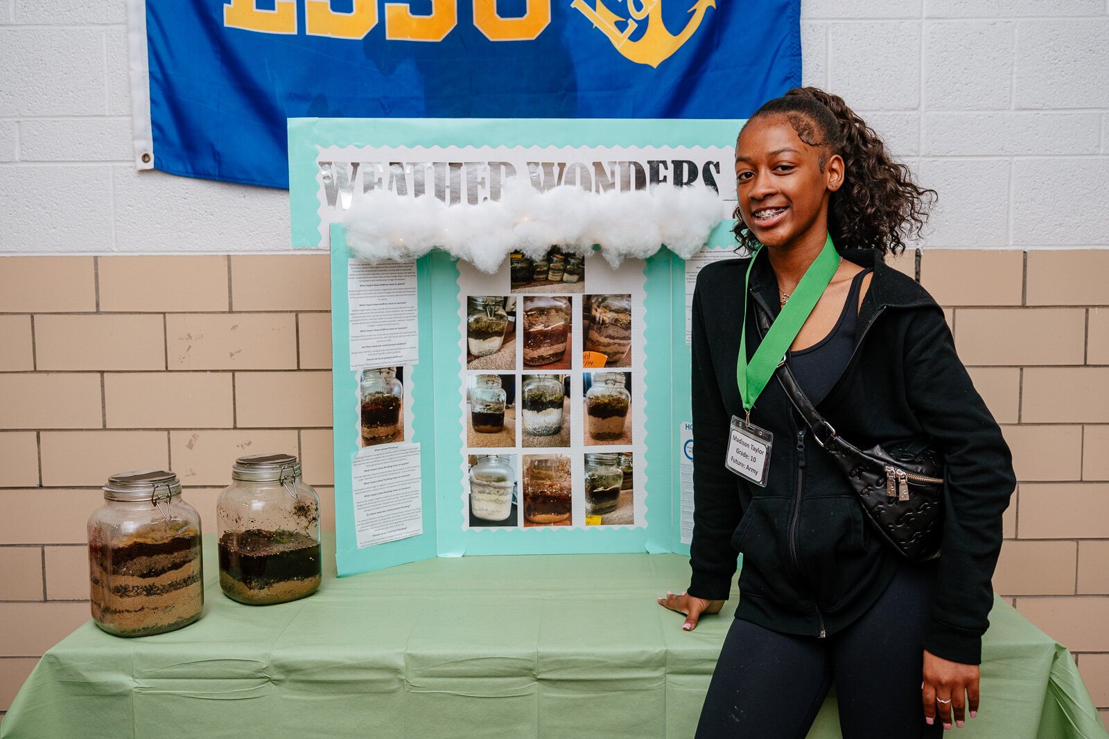 Supplemental Science student Madison Taylor with her exhibit on soil samples at a science fair at WAY Academy in Detroit.