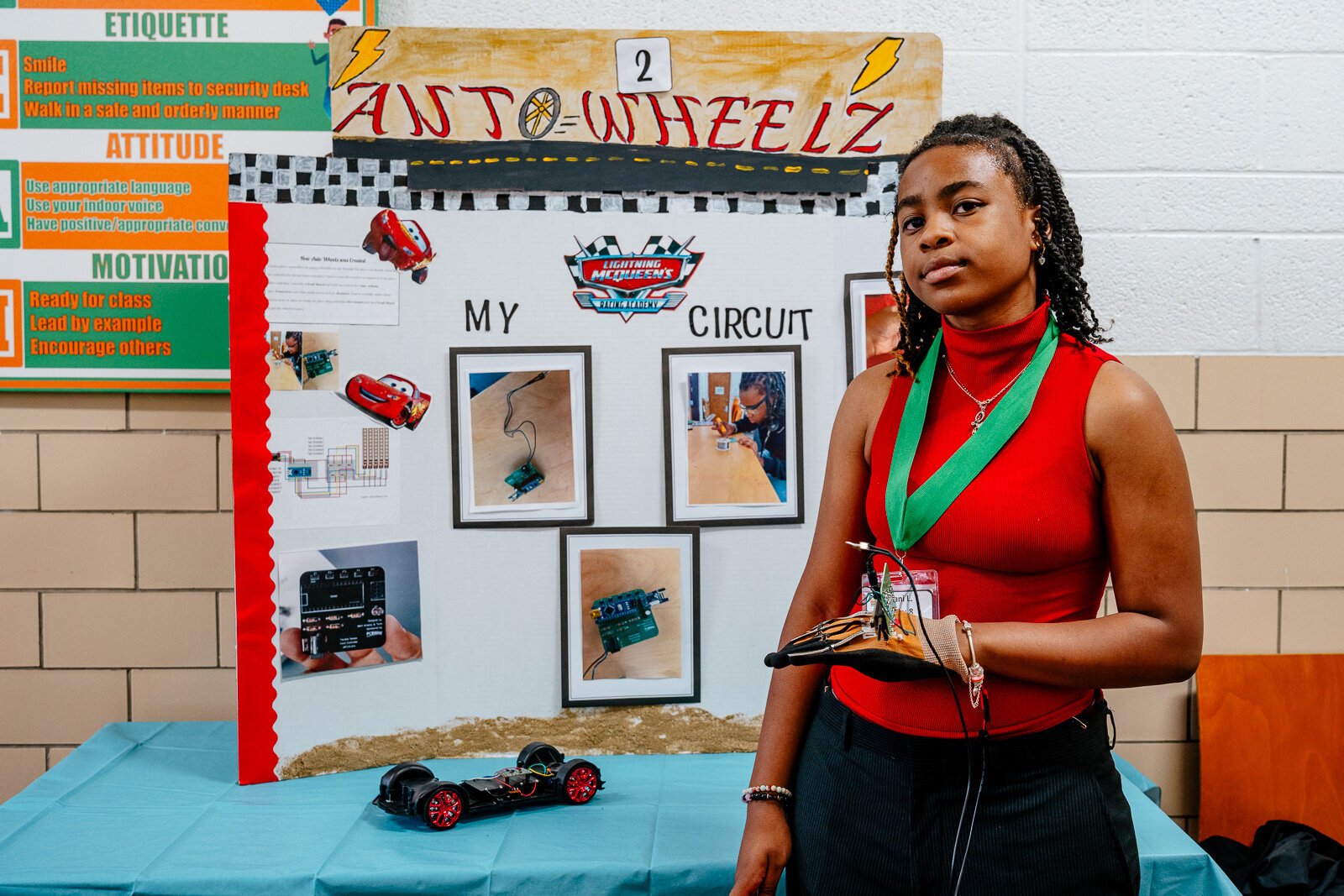 Supplemental Science student Emani Lawson shows off a circuit glove she made that can be used to control an RC car.