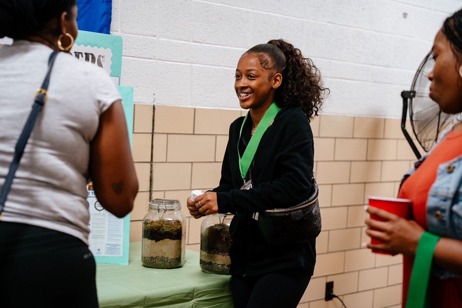 Supplemental Science student Madison Taylor shows off her exhibit on soil samples at a science fair at WAY Academy in Detroit.
