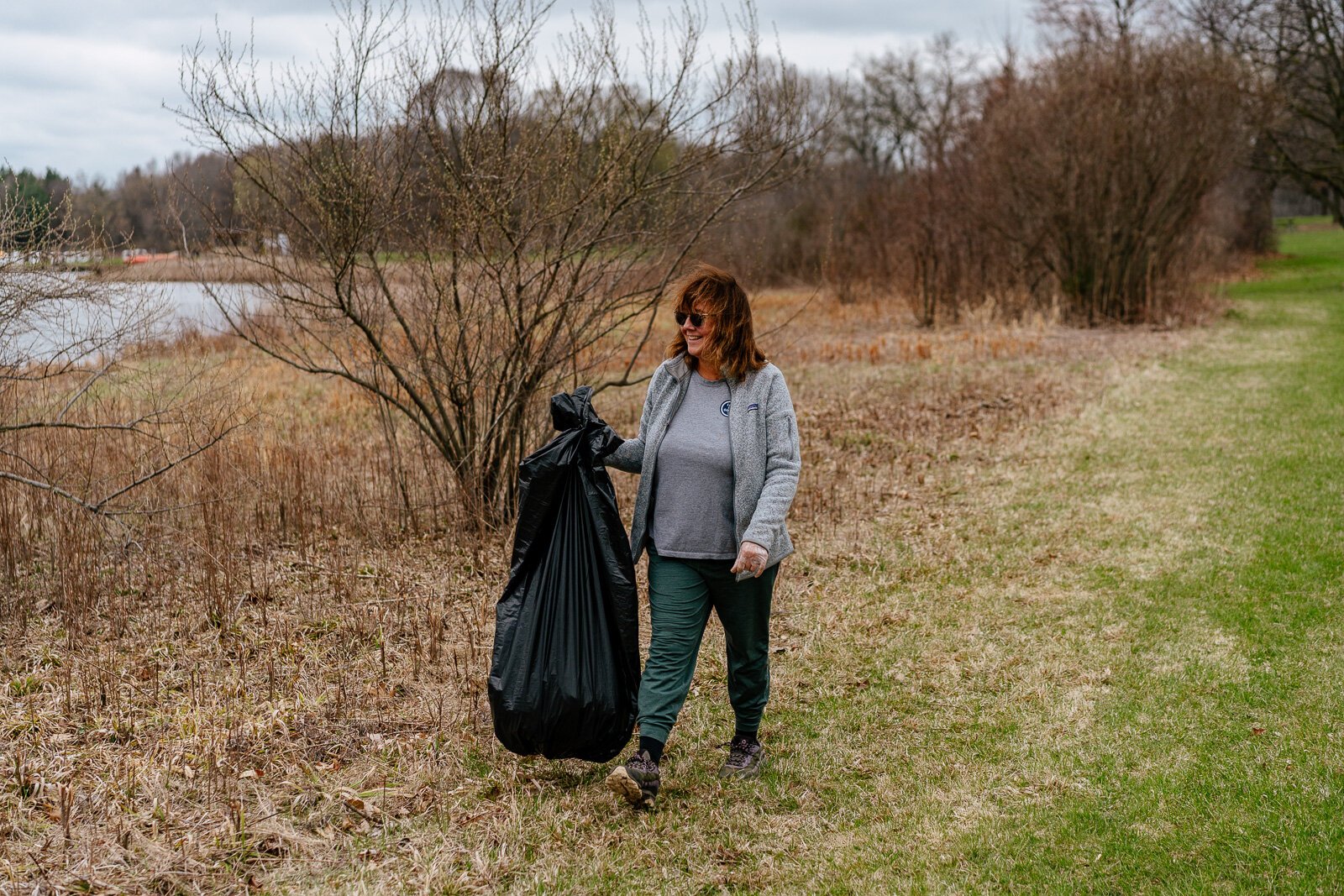 Roz Nowosielski picks up trash at Stony Creek Metropark during an Earth Day cleanup event. She walks at the park every day and wanted to help clean it up.