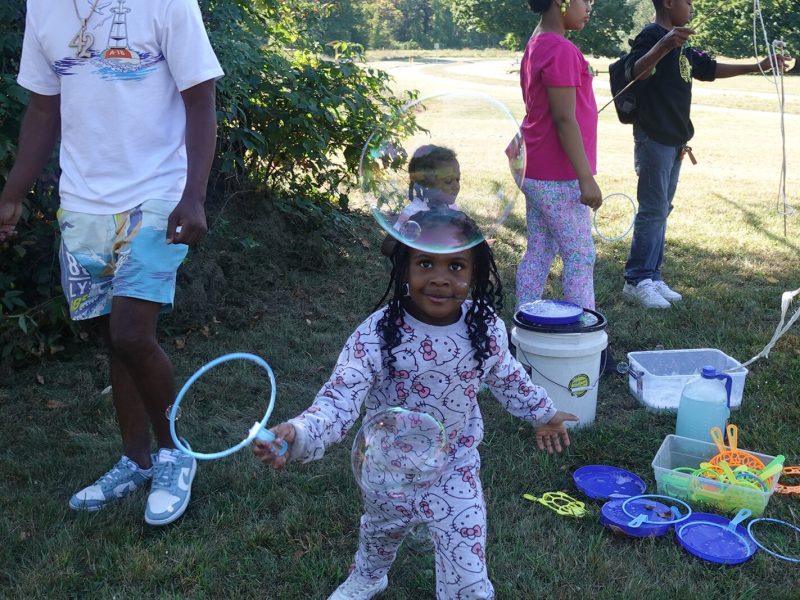 Children play during a campout at Eliza Howell Park.