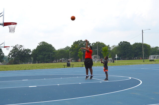 Kids play on a basketball court at O'Hair Park.