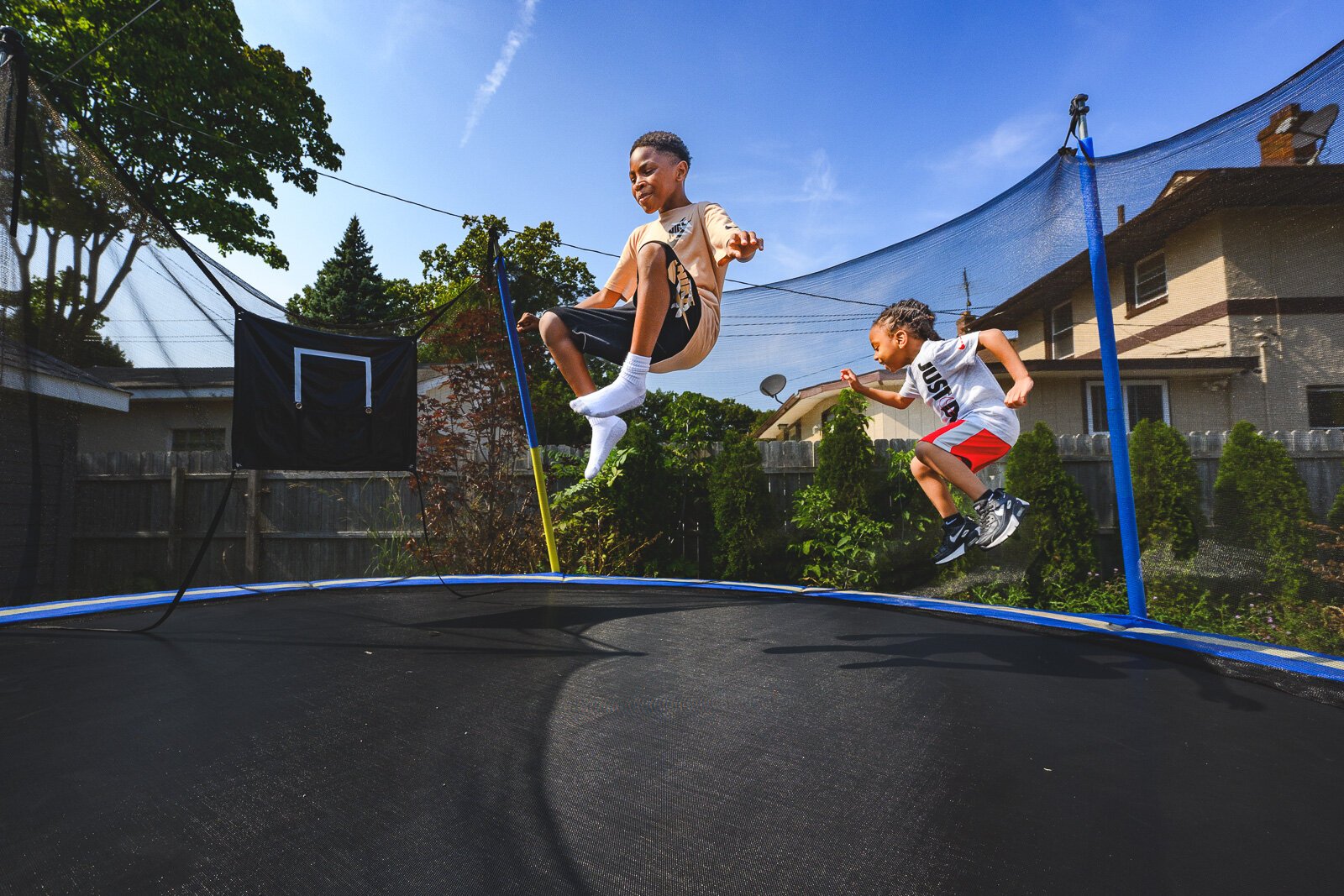 Dallas and Dayton Palmer play on a trampoline in their backyard.