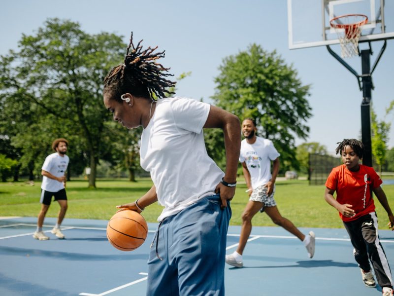 People play basketball during a Pistons Neighbors program session in Rouge Park.