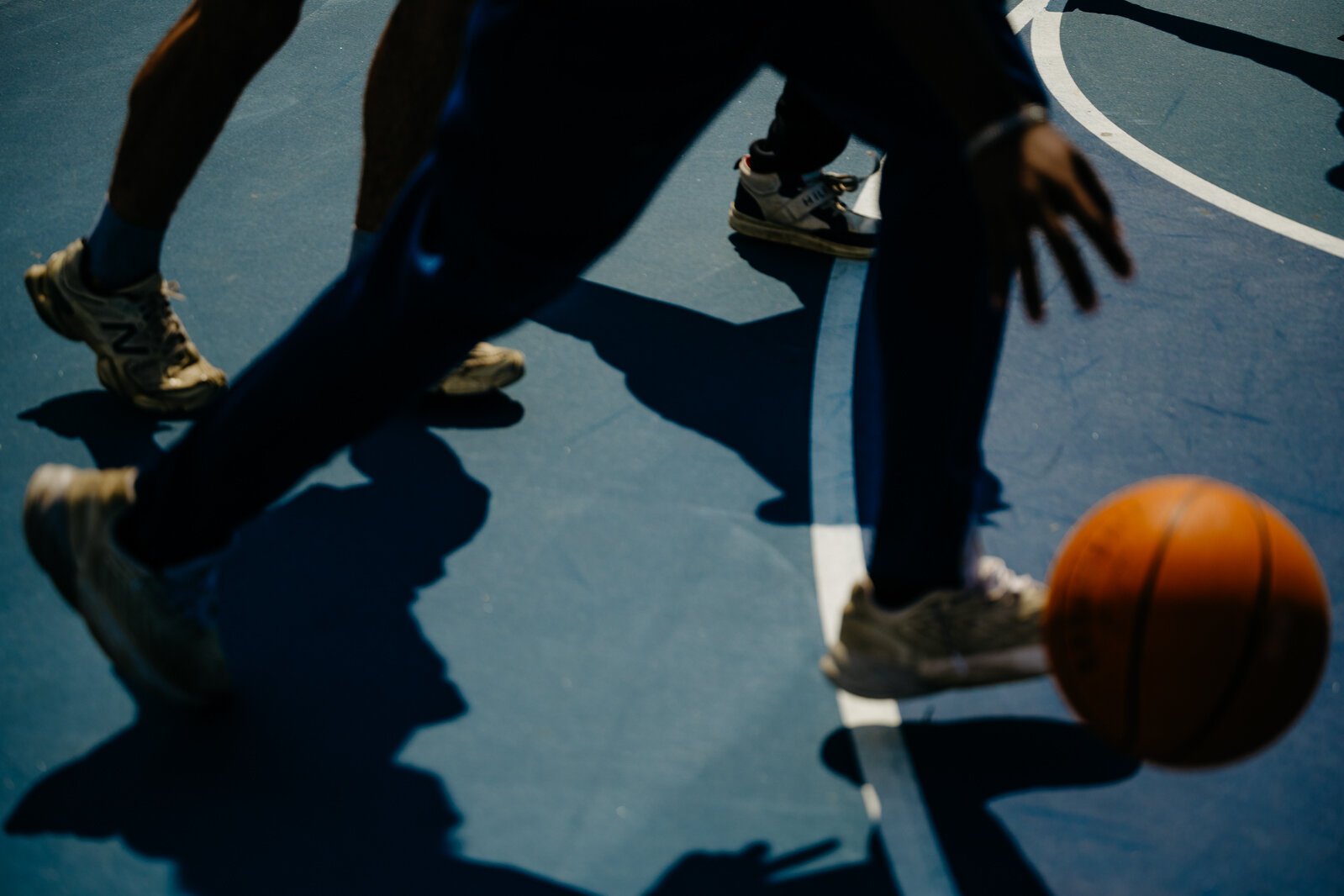 People play basketball during a Pistons Neighbors program session in Rouge Park.