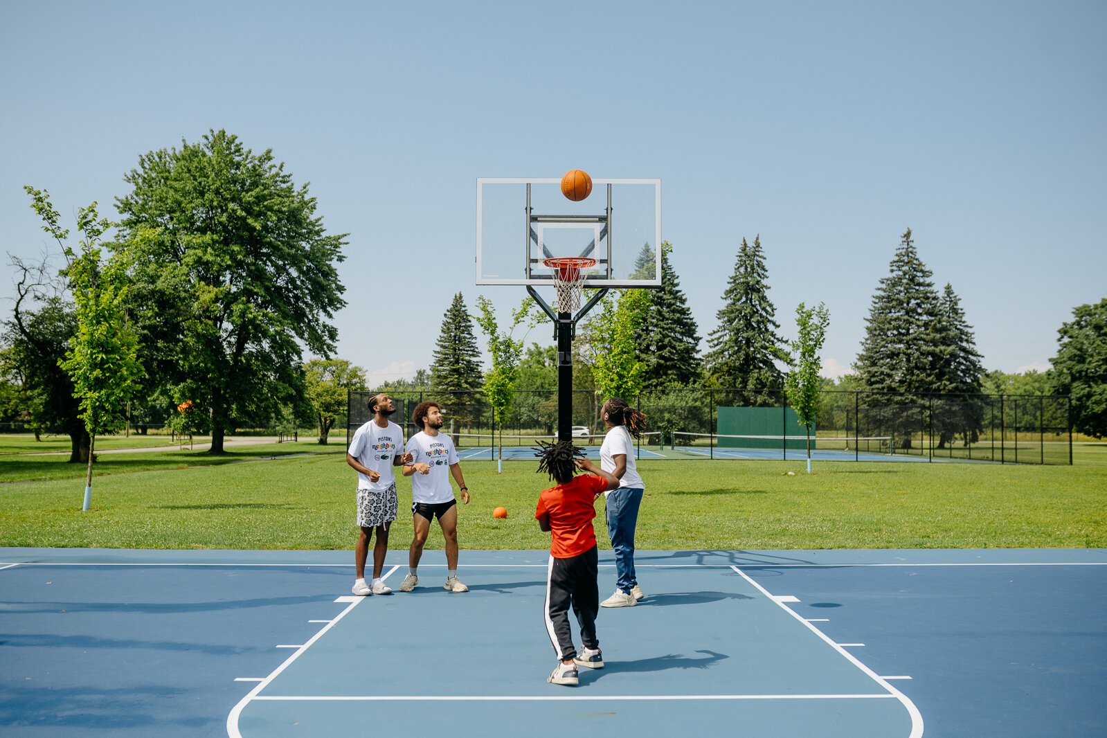 People play basketball during a Pistons Neighbors program session in Rouge Park.