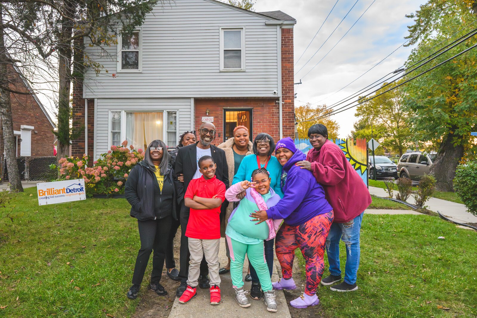 Detroit Champions for Hope staff, parents, and kids pose in front of Brilliant Detroit's Osborn House.
