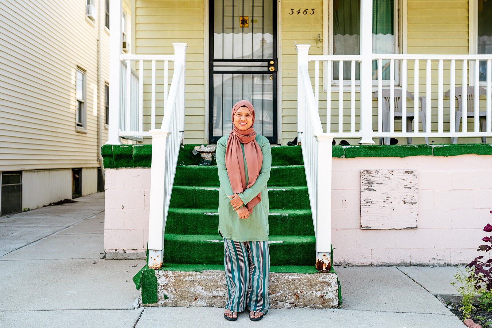 Rebeka Islam in front of her childhood home on Yemans Street.