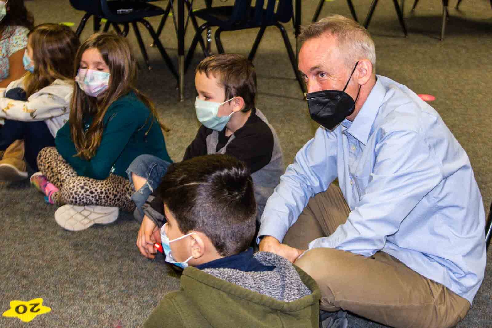 Ethan Alexander sits with students at Kalamazoo's Northwood Elementary as they discuss their feelings.