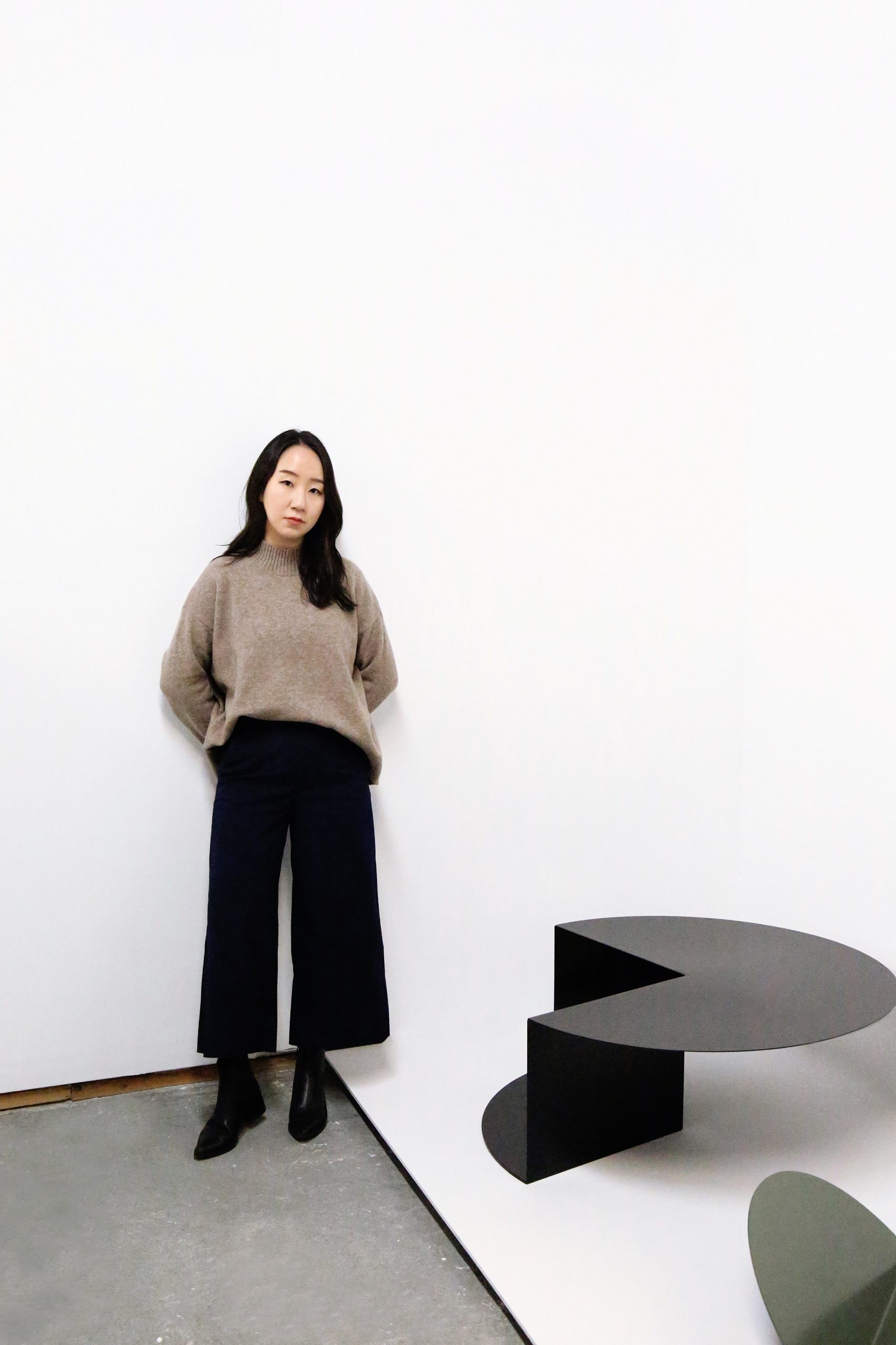 Detroit-based artist and designer Nina Cho with her Cantilever Table.