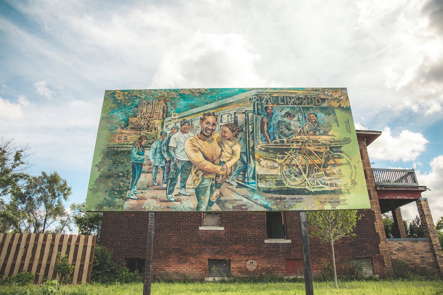 The mural, titled “The Waiting” by Nicole Macdonald, shows NW Goldberg residents boarding the 29 Linwood bus at the corner of Linwood and Ferry Park.