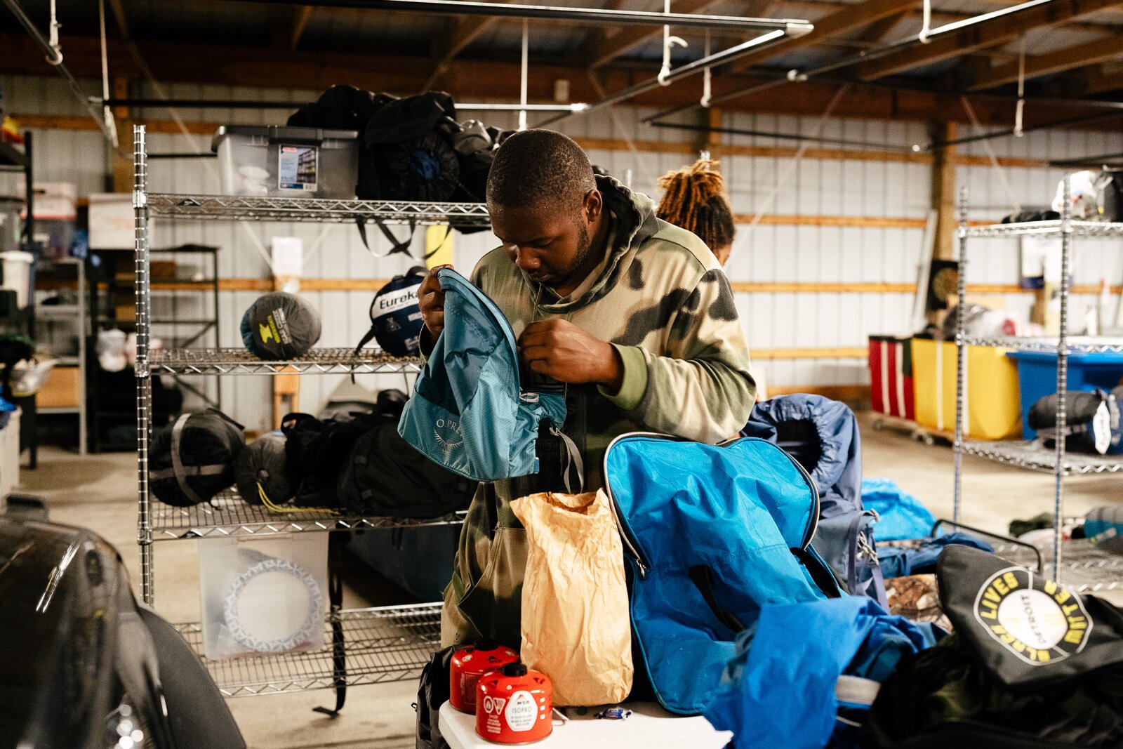 A camper unpacks gear after a Detroit Outdoors trip to Pictured Rocks.