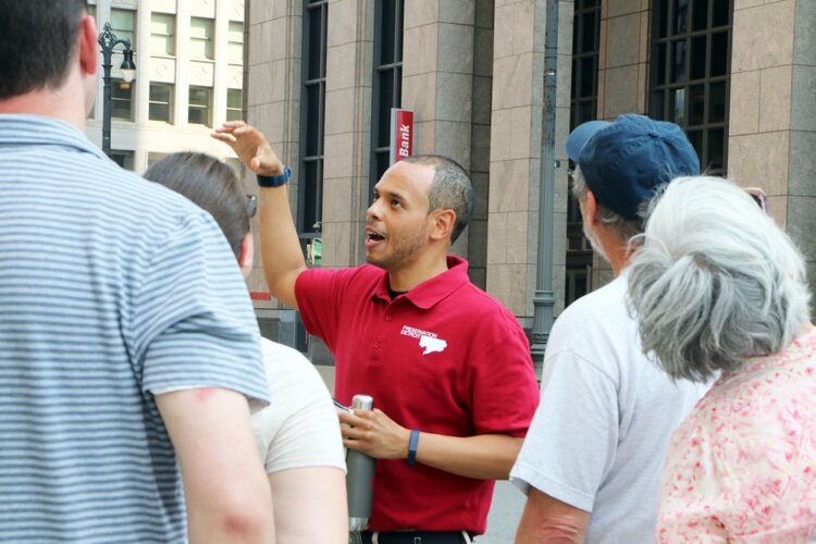 A Preservation Detroit guide leads a tour downtown.