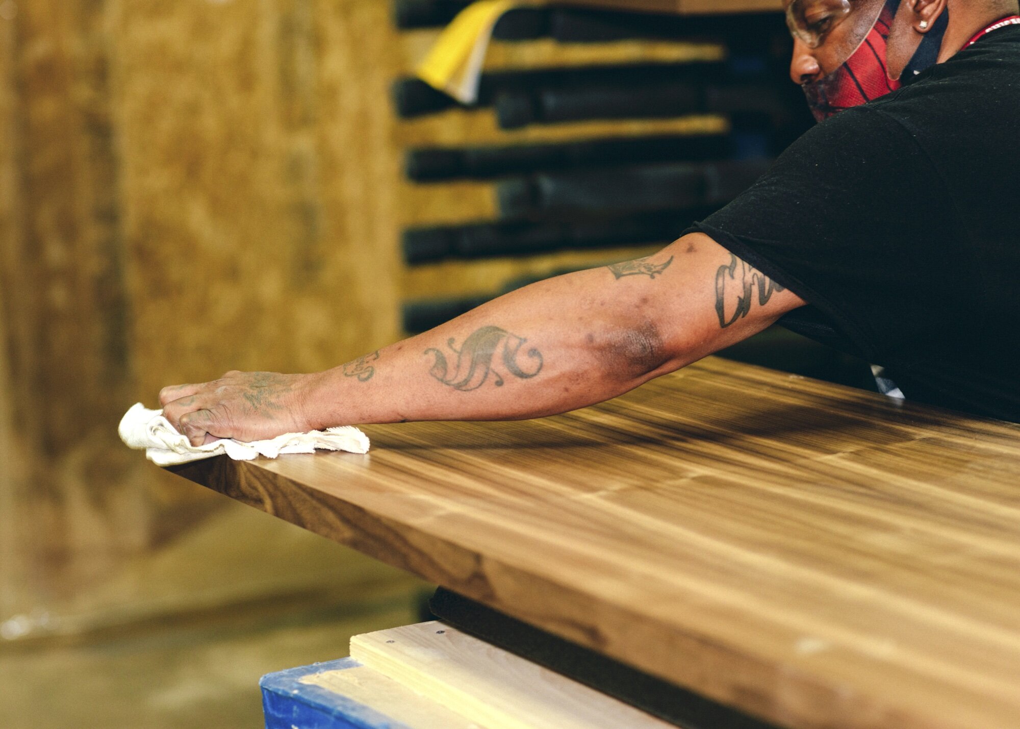 A Floyd Bed panel is given its final dusting before heading to packaging. This panel and support system allows for the bed to change in size, with just the addition of another panel.