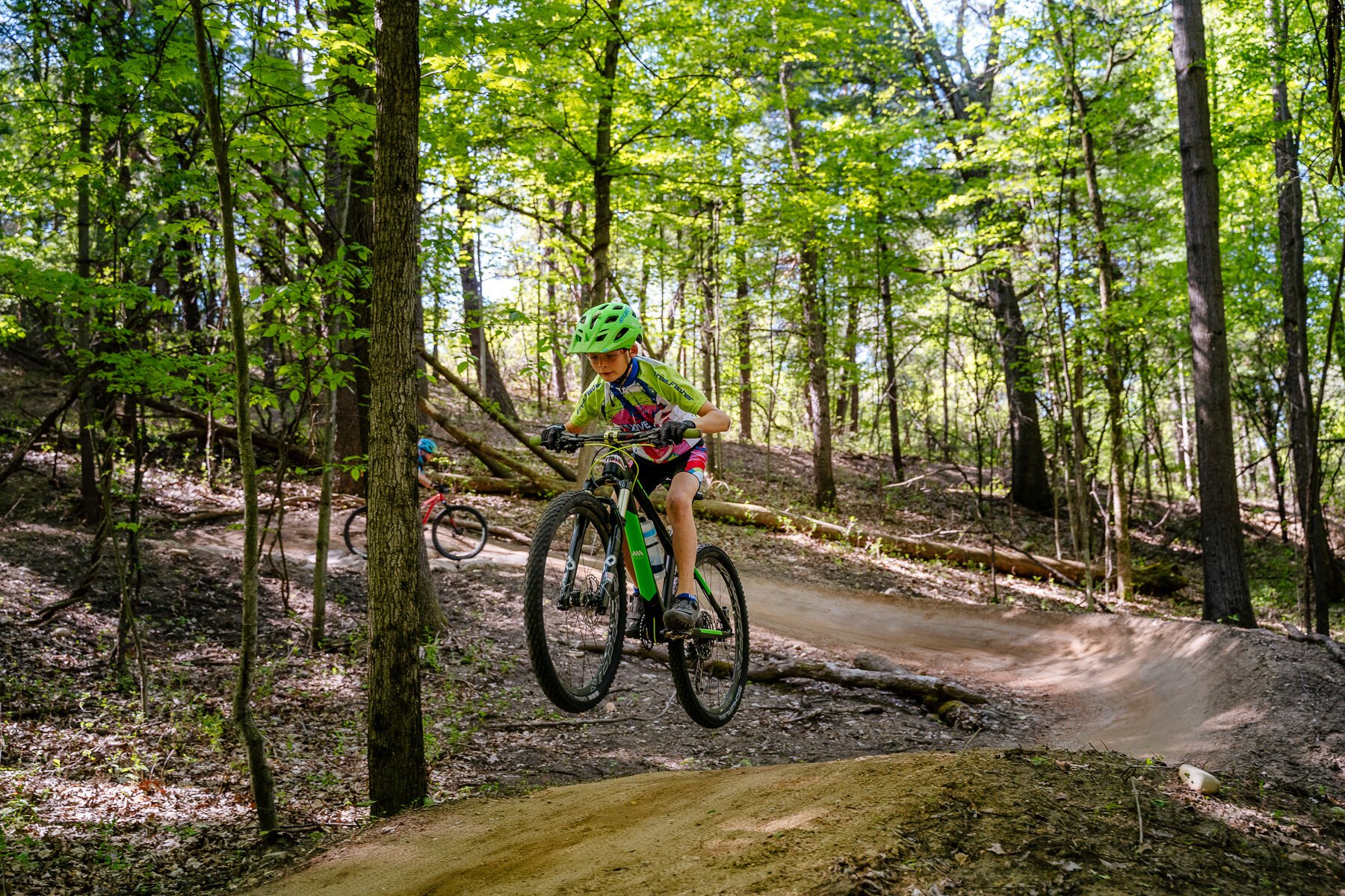 Tyler Pokowski does a jump on his mountain bike at the Shelden Trails at Stony Creek Metropark.