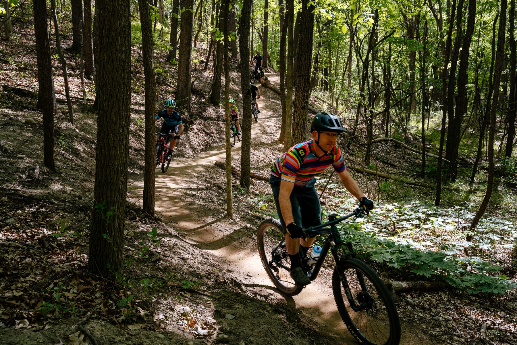 Steve Vigneau, lead volunteer of Clinton River Area Mountain Biking Association (CRAMBA), leads a group of mountain bikers at the Shelden Trails at Stony Creek Metropark.