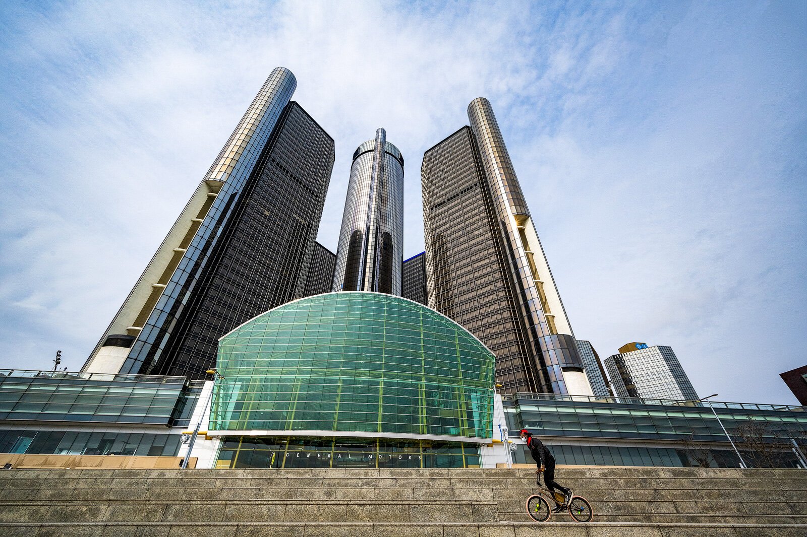 A person bikes along the Detroit Riverwalk.
