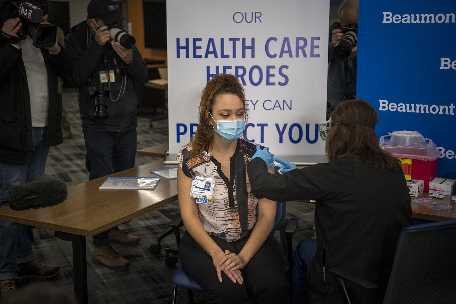 Susan Grant administers the first dose of the COVID-19 vaccine to RN Saaja Rayford at Beaumont Service Center in Southfield on Dec. 15, 2020.