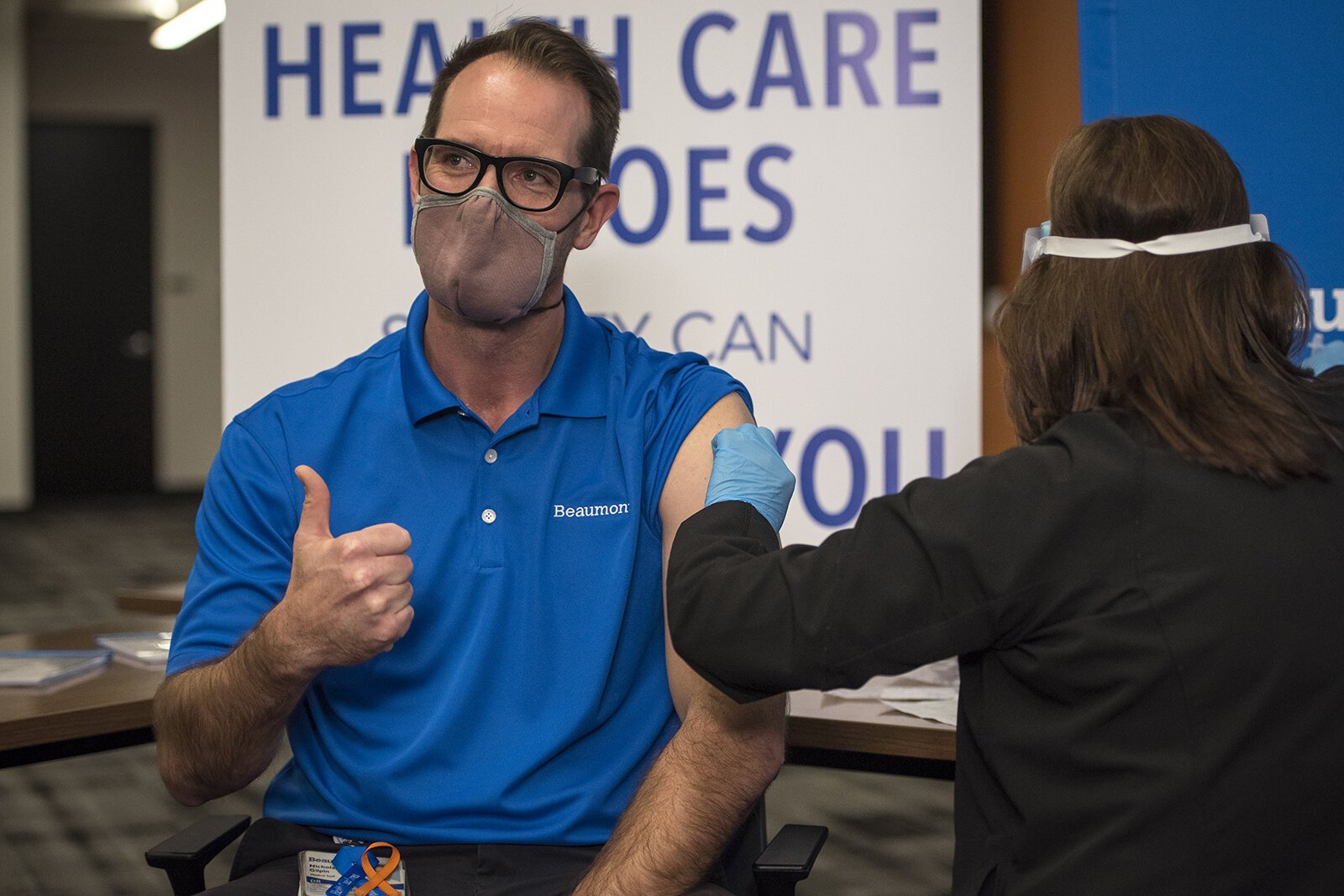 Dr. Nick Gilpin gives a thumbs up after receiving the first dose of the COVID-19 vaccine at Beaumont Service Center in Southfield on Dec. 15, 2020.