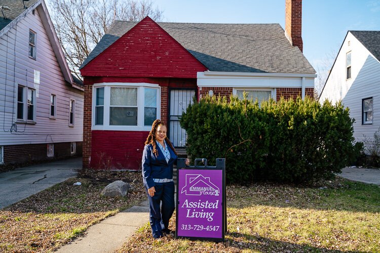 Renee White stands in front of Emmanuel House 1.