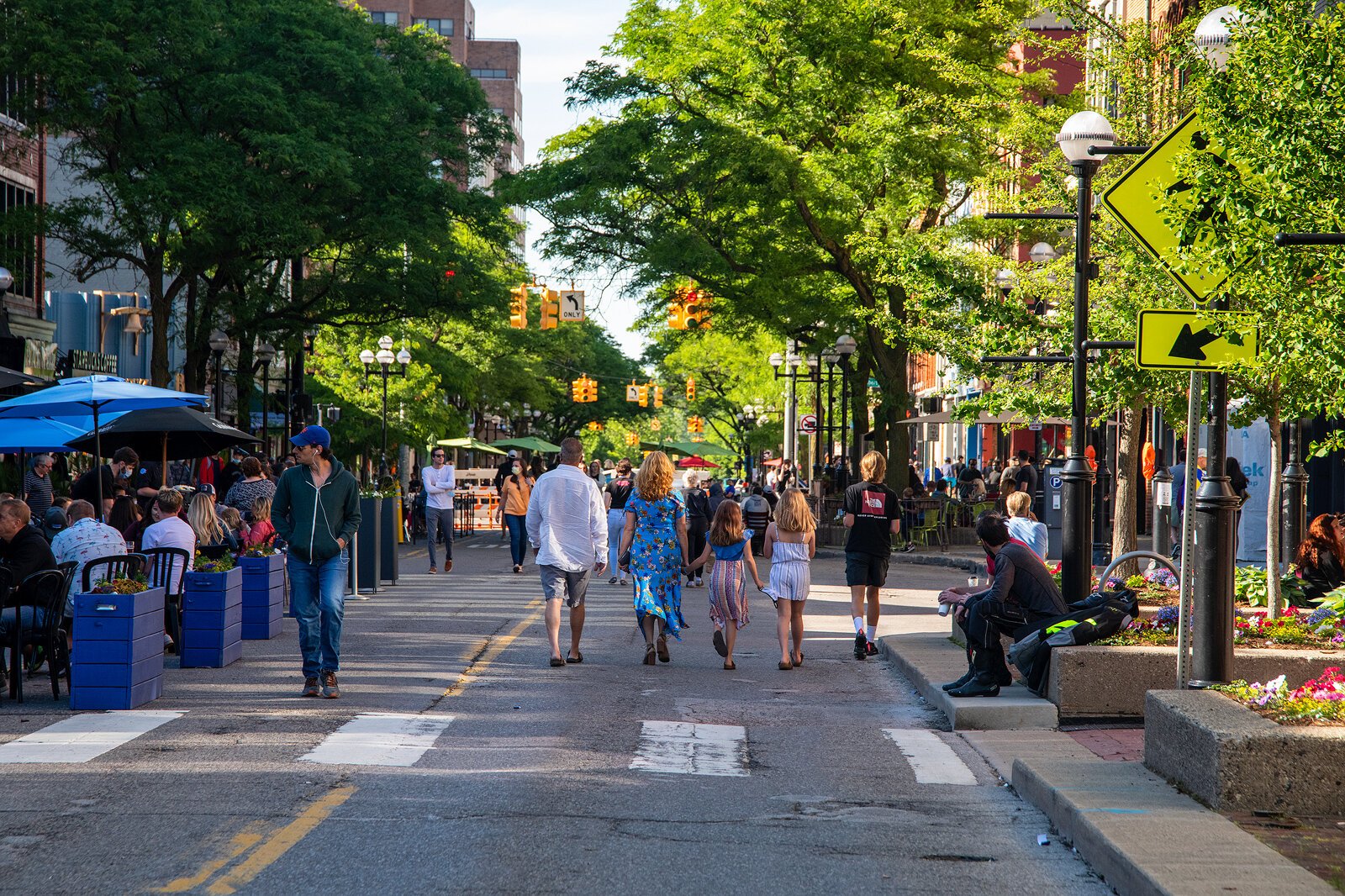 People walk down Main Street in Ann Arbor.