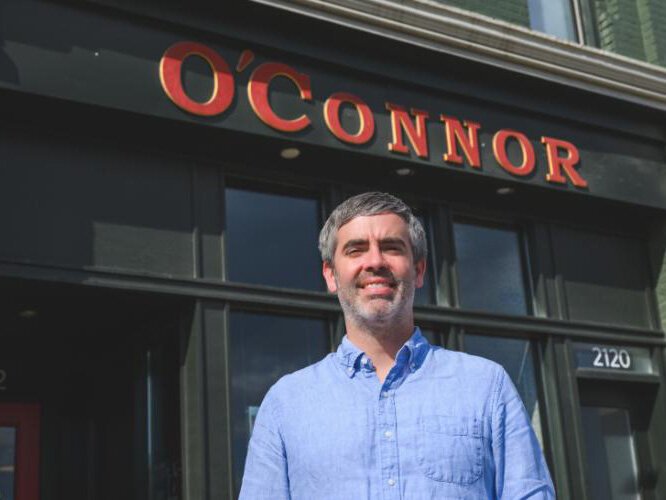 Ryan Cooley stands outside his real estate office on Michigan Avenue, in the same block as Slow's BBQ.
