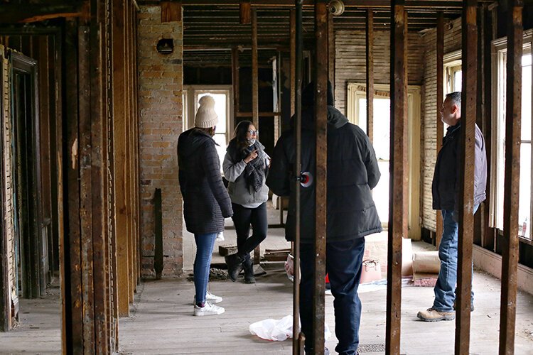 Tanya Saldivar-Ali talks with her team at AGI Construction as they remodel a building on 18th Street.