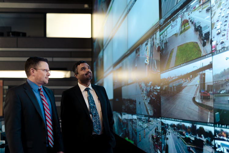 Traffic Engineer Adam Merchant and John Abraham, Macomb County Director of Traffic and Roads, monitoring traffic at COMTEC