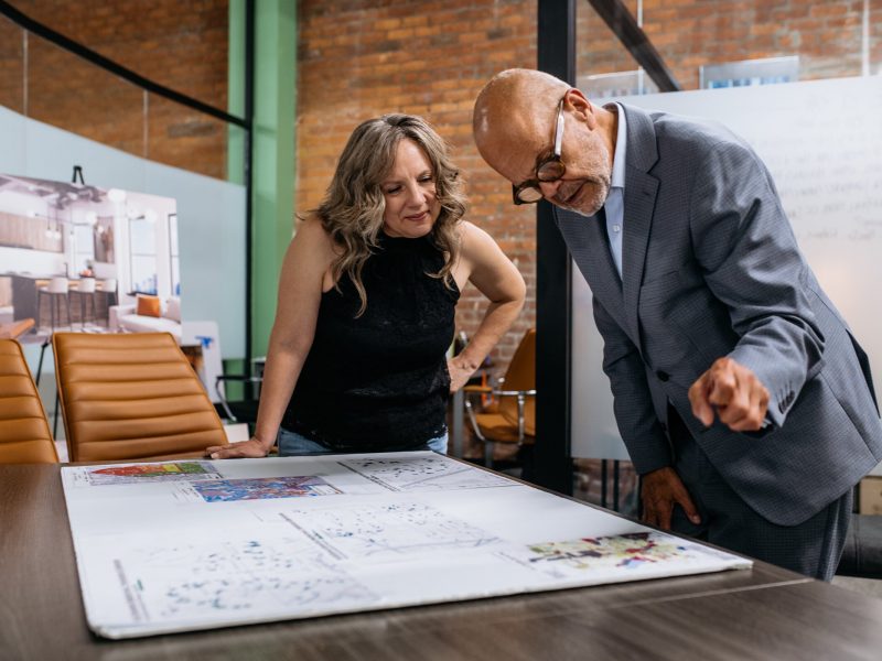 Leah DuMouchel, director of programs and communications at the Michigan Association of Planners, and Vern Gustafsson, project director/planner at the Pontiac Housing Development Corporation, look over zoning maps.
