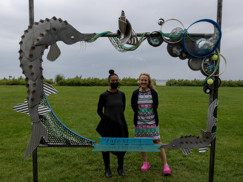 Artist Halima Cassells and Huron-Clinton Metroparks CEO Amy McMillan stand with Cassells' new art installation at Lake St. Clair Metropark.